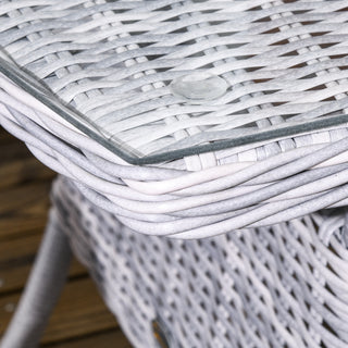 Close-up of the Outsunny Garden PE Rattan Dining Sofa Set’s tempered glass coffee table, with a transparent rubber bumper on the corner—an elegant addition to your patio, this mixed grey wicker set complements outdoor spaces beautifully.