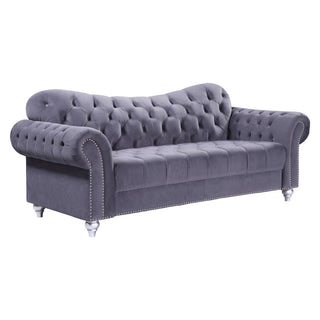The Jubilee Grey Velvet 3 Seater Sofa by Beehive Furniture features button-tufted back and seat, rolled arms, silver nailhead trim, and short silver legs—a stylish modern design for your living room.
