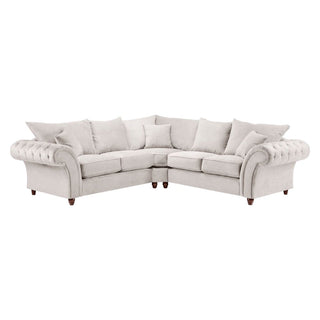 A light gray, L-shaped corner sofa with tufted arms, wooden legs, and matching throw pillows offers a look reminiscent of Beehive Furniture’s Windsor Beige Fabric Large Corner Sofa with plush cushions and elegant design.