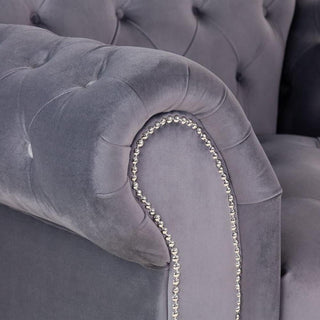 Close-up of a tufted, light-gray velvet armchair with silver nailhead studs from Beehive Furniture—an elegant match for the Jubilee Grey Velvet 3 Seater Sofa | Modern Design | Button-Tufted Elegance.