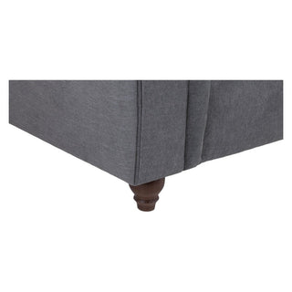 Close-up of the bottom corner of the Beehive Furniture Windsor Fullback Grey Corner Sofa (Left Hand Facing, Button-Tufted Arms) showing a dark wooden leg against a white background.