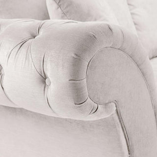 Close-up of a light gray, tufted armrest with button detailing and a curved design on the Beehive Furniture Windsor Beige Fabric Large Corner Sofa, featuring plush cushions and an elegant look.