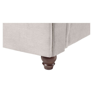 Close-up of the Beehive Furniture Windsor Beige Fabric Large Corner Sofa, highlighting its light beige upholstery and dark brown wooden turned leg.