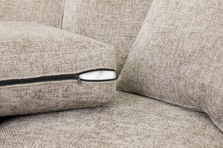 Close-up of the Nebraska Beige Fabric 3 + 2 Seater Sofa by Beehive Furniture, showing a seat cushion with a partly unzipped cover and white padding. The textured, woven upholstery highlights its elegant comfort and luxurious design.