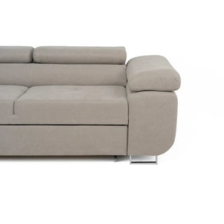 A close-up of the right side of the PF Sofas SOFAINSTORE Ferrano Beige Fabric Corner Sofa Bed, L-shaped with plush cushions, metal leg, fold-out sleeper, and hidden storage, shown against a white background.
