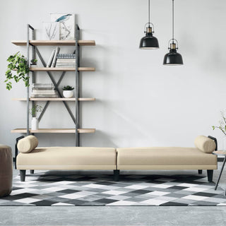 Modern minimalist living room with the vidaXL Sofa Bed with Armrests Cream Fabric, a geometric black-and-white rug, open shelves with books and plants, a pouf, and two black pendant lights hanging from the ceiling.