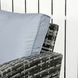 A close-up of the Outsunny 6 Pieces Rattan Garden Furniture Set, a 7-seater grey wicker outdoor sofa set with cushions, seen in front of a white wooden fence.