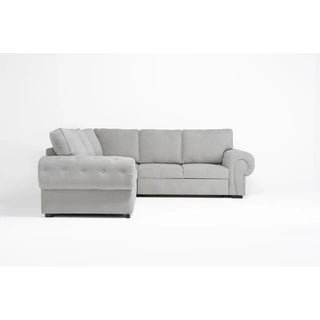 The PF Sofas SOFAINSTORE Light Grey Fabric Corner Sofa Bed features rolled arms, deep seats, tufted cushions, and hidden underseat storage, shown on a plain white background.