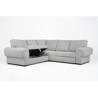 The PF Sofas SOFAINSTORE Light Grey Fabric Corner Sofa Bed features rolled arms, deep seats, and hidden underseat storage, shown against a plain white background.