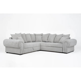 The PF Sofas SOFAINSTORE Grey Fabric Chesterfield Corner Sofa Bed features scroll arms, tufted detailing, matching pillows, pull-out sleeper, and storage, all shown in light gray against a plain white background.