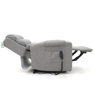 The RS Furniture SOFAINSTORE Bramley Grey Electric Rise & Recline Armchair is shown fully reclined with its footrest extended. A corded remote attaches to the side, and the chair features padded back and armrests for comfort.