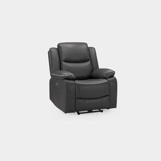 A modern living room features the Beehive Furniture SOFAINSTORE Harald Black Leather Electric Recliner Armchair with power recline and contrast stitching on a light wood floor and beige rug, accented by a lamp, white curtains, framed art, and a vase by the window.