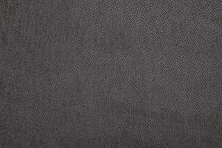 A close-up of a textured dark gray surface, echoing the soft, grainy fabric of the Beehive Furniture Kiana Modular Sofa | Grey Fabric | Large Corner Design, highlighting its luxurious modular appeal.