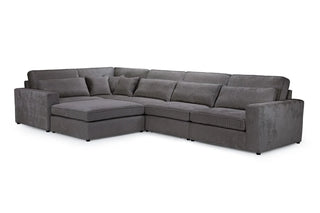The Kiana Modular Sofa by Beehive Furniture features a large grey fabric corner design with wide armrests, plush back cushions, and a left-side chaise for customizable comfort and versatile modular seating.