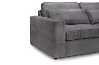 A close-up of the Beehive Furniture Kiana Modular Sofa | Grey Fabric | Large Corner Design showcases its modular build with detailed armrest, seat cushions, and backrest against a plain white background.