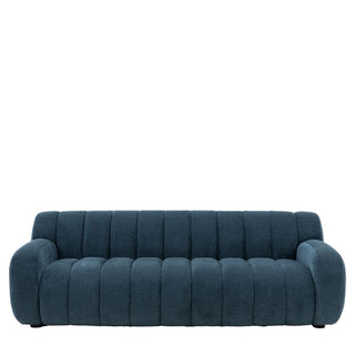 The Coste Fabric 3 Seater Sofa by Gallery Direct features blue upholstery, retro design, rounded armrests, and vertically channeled tufting on the back and seat—shown against a plain white background.