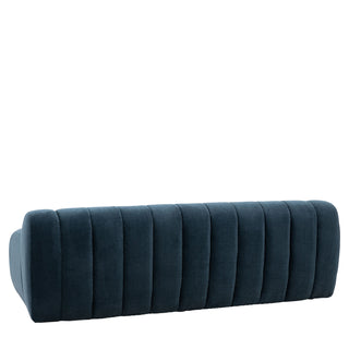 The Gallery Direct Coste Fabric 3 Seater Sofa in blue upholstery features a retro design with vertical channel tufting on the backrest, shown from the rear against a white background.