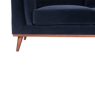 Close-up of the Maili Velvet Fabric 2 Seater Sofa by Twenty Ten Designs in midnight blue, showing its cushioned comfort, wooden legs, and base against a white background.