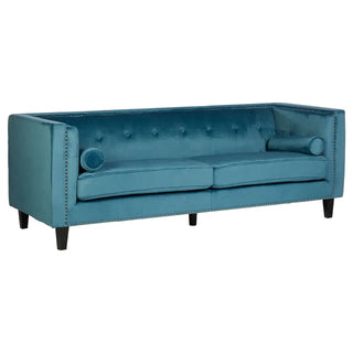 The Felisen Upholstered Velvet 3 Seater Sofa by Premier Sofas features elegant blue velvet, square arms, a tufted back, two seat cushions, nailhead trim, bolster pillows, and sturdy dark wooden legs for modern living rooms.