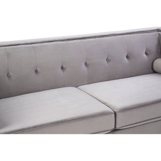 A close-up of the Felisen Grey Velvet 3 Seater Sofa by Premier Sofas shows its button-tufted backrest, smooth seat cushions, silver nailhead trim, and sturdy eucalyptus frame—an ideal luxury sofa choice for UK homes.