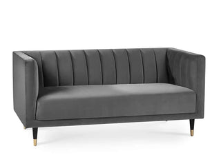 The Julian Bowen SOFAINSTORE Savona Grey Velvet 2 Seater Sofa features a channel-tufted back, luxe modern style, and gold-tipped black legs—a striking piece among luxury sofas UK.