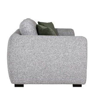 Side view of the Vida Living Santiago Fabric 2 Seater Sofa in grey upholstery with two dark green accent pillows, rounded armrest, and black legs, shown against a plain white background.
