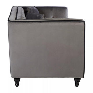 Side view of the Hannah Upholstered Velvet 3 Seater Sofa in Grey Elegance by Premier Sofas, featuring a tufted backrest, black piping, and turned wooden legs—a chic choice for luxurious UK-style living rooms.