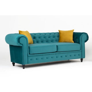 The PF Sofas SOFAINSTORE Florencia Ocean Teal Chesterfield 2-seater, with scroll arms and button-tufted luxe velvet upholstery, stands against a white background, adorned with two mustard yellow accent pillows for a vibrant touch.
