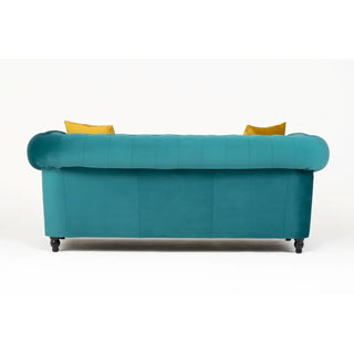 The PF Sofas SOFAINSTORE Florencia 2 Seater Chesterfield in ocean teal velvet features scroll arms, button tufting, and dark short legs. Two yellow accent pillows peek over the back against a plain white background.
