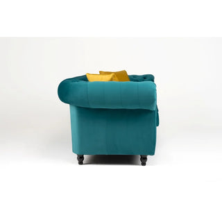 Side view of the PF Sofas SOFAINSTORE Florencia Ocean Teal Chesterfield 2 Seater, featuring luxe velvet upholstery, scroll arms, button tufting, and two yellow throw pillows, set against a plain white background.