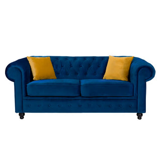 The PF Sofas SOFAINSTORE Florencia Navy Blue Fabric Chesterfield Sofa – 2 Seater features scroll arms, button tufting, luxe velvet upholstery, and two yellow throw pillows, shown against a white background.