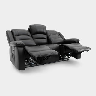 The Beehive Furniture SOFAINSTORE Arclay 3 seater black leather electric recliner sofa features padded armrests, two extended footrests, and a drop-down cupholder console—ideal for luxury sofas UK style. Displayed on a plain light gray background.