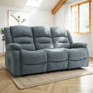The Beehive Furniture SOFAINSTORE Arclay Grey Fabric Recliner Sofa—3 Seater with electric recline and drop-down cupholder console—stands out on a beige rug in a bright, modern living room with wooden floors and large windows.