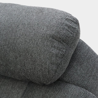Close-up of a dark gray, textured cushion with visible stitching on the Beehive Furniture SOFAINSTORE Arclay Grey Fabric Recliner Sofa – 3 Seater. The plush padding adds comfort and style to this modern electric recliner with drop-down cupholder console.