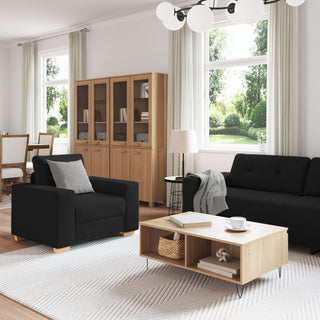 A modern living room features the vidaXL 3-Piece Sofa Set with Cushions in Black Fabric, a light wood coffee table, and matching cabinet. Large windows with white curtains brighten the space, while a dining area complements this stylish vidaXL set.