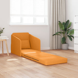 The vidaXL Floor Sofa Bed 2-in-1 in dark yellow (65x80x83 cm) is extended into a bed in a modern, sunlit room with light wood floors, window blinds, a potted plant, and a side table topped with a vase.