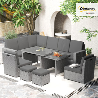 The Outsunny Seven-Piece Rattan Garden Sofa Set in Light Grey features sofas, two stools, a bench, and an expanding glass-top table on stone tiles among greenery and a white brick wall. Outsunny logo at top right.
