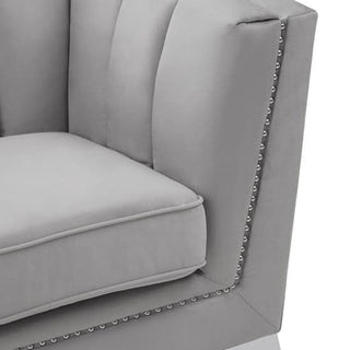 Close-up of the Hefei Velvet 2 Seater Sofa by Premier Sofas, featuring grey fabric upholstery, chrome metal legs, and modern design—an ideal accent for your contemporary living room décor.