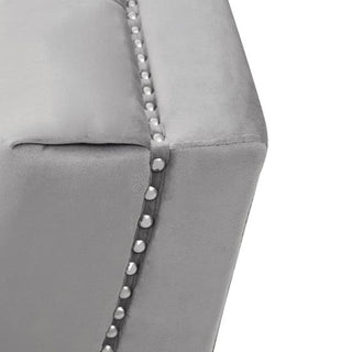 Close-up of the Hefei Velvet 2 Seater Sofa by Premier Sofas, featuring grey fabric, chrome metal legs, and silver nailhead trim—showcasing soft texture and neat stitching for a modern living room.