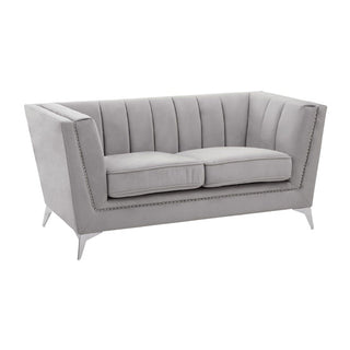 The Hefei Velvet 2 Seater Sofa by Premier Sofas features light grey fabric, vertical channel tufting, two seat cushions, and chrome metal legs—an elegant modern choice for your living room.