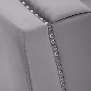 Close-up of the Hefei 3 Seater Sofa by Premier Sofas in grey velvet, featuring chic chrome metal legs and a row of metallic studs along the seam—an elegant modern detail for stylish living rooms.