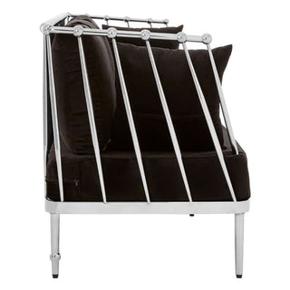 Side view of a modern black armchair with metal frame and plush cushions, ideal to pair with the Nestium Black Velvet Fabric 3 Seater Sofa | Silver Frame | Luxurious Comfort Design for an elegant living room.
