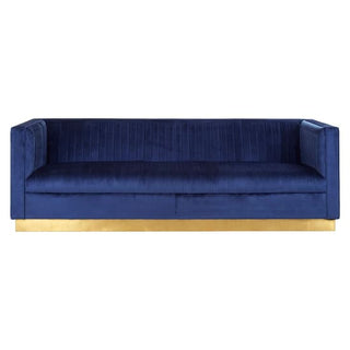 The Deep Blue Velvet 3 Seater Sofa by Premier Sofas features an elegant design with vertical stitching, a rectangular silhouette, and a gold base for a modern touch.