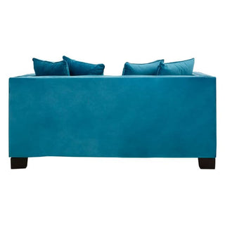 The Premier Sofas Pipirima Upholstered Velvet 2 Seater Sofa in cyan blue fabric is shown from the back, featuring four matching cushions and short black legs for a modern look.
