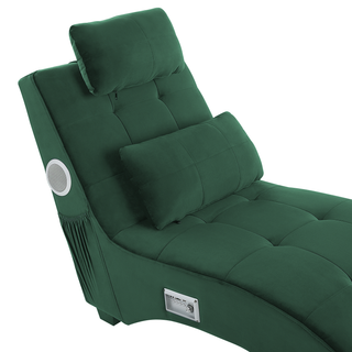 The Beliani SOFAINSTORE Maestro Green Velvet Chaise Lounge features Bluetooth speakers, a USB port, modern tech design, two cushions, a storage pocket on the side, and a control panel on the lower side of the chair.