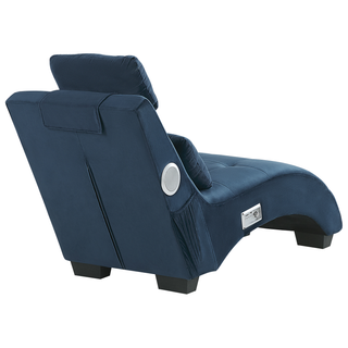 The Beliani SOFAINSTORE Blue Velvet Fabric Chaise Lounge features tufted upholstery, inbuilt Bluetooth speakers, a USB charging port, and a cushioned headrest, shown from the rear on a white background.
