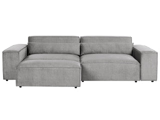 The Beliani SOFAINSTORE Grey Fabric 4 Seater Sofa features an oversized modern design with deep cushions and wide armrests for lounge comfort, making it a perfect addition to any modern living room. Set against a white background for a stylish look.