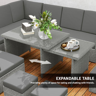 The Outsunny Seven-Piece Rattan Garden Sofa Set in light grey features an expanding glass-top table, perfect for outdoor spaces. Shown with gray cushions, coffee cups, flowers, and books on a wooden patio. Text: EXPANDABLE TABLE.