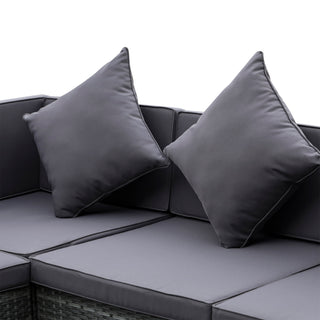The Outsunny 7 Pieces Patio Wicker Sofa Set features grey cushions and two matching throw pillows, with an acacia tabletop—ideal modern garden furniture for backyards or patios. Outdoor PE rattan sectional is shown on a white background.