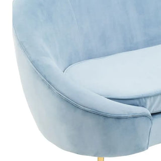 The Premier Sofas Aqua Blue Velvet 3 Seater Sofa features curved lines, a plush seat cushion, and elegant gold metal legs for a modern look.